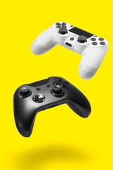 White and black game controllers on yellow background © miglagoa