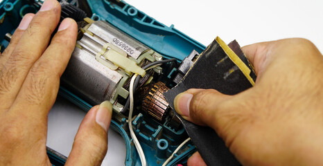 Repair and check the damaged electric drill.(Selective focus)