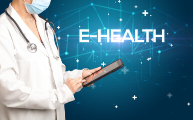 Doctor fills out medical record with E-HEALTH inscription, medical concept