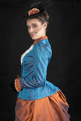 A young Victorian woman wearing an 1880s ensemble