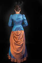 A young Victorian woman wearing an 1880s ensemble