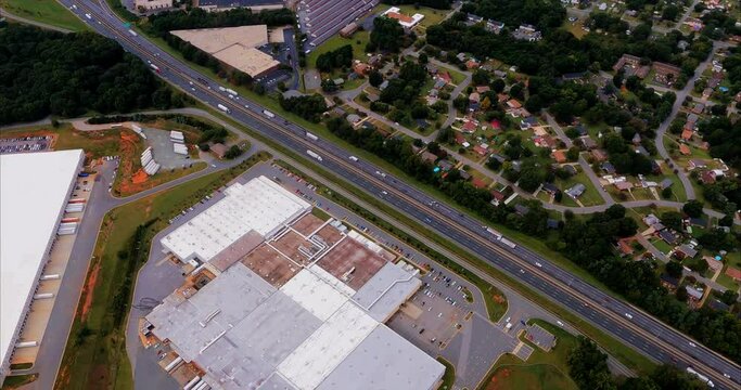 Factory, Food Distribution, Interstate, and Storage Facility.  This is a feature packed flyover showing a factory,  food distribution warehouse, interstate I-85,a neighborhood, self storage facility, 