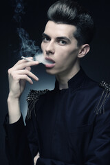 Young stylish man smoking a cigarette