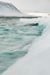 Obraz premium Sea water meeting with snow in Iceland fjords 
