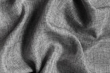 Gray textured fabric background with large folds.
