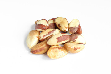 Pile of brazil nuts isolated on white background. Delicious treat delicacy