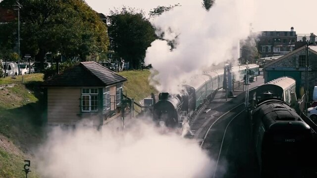 Vintage steam train departure from Swanage train station