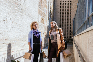 women walking down the street with their purchases