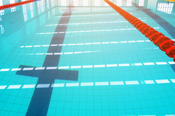 Track & lanes of a competition swimming pool..Indoor swimming pool with empty lanes..Olympic standard swimming pool &  diving pool, water and lines ,