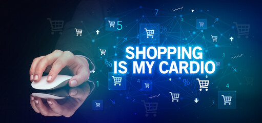 hand holding wireless peripheral with SHOPPING IS MY CARDIO inscription, online shopping concept