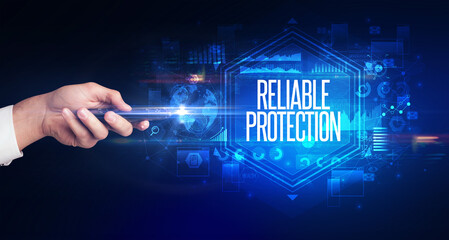 hand holding wireless peripheral with RELIABLE PROTECTION inscription, cyber security concept