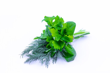 A bunch of fresh herbs. Dill, parsley, spinach. White background.