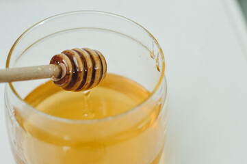 Fototapeta na wymiar Honey jar with wooden dipperP