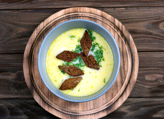 Cheese soup on a round wooden stand.Top view