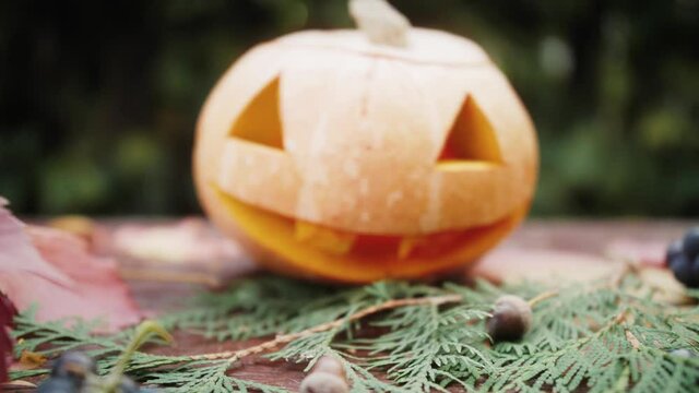 Happy Halloween Scary Halloween pumpkin face in the dark. Close-up of a scary pumpkin decor.