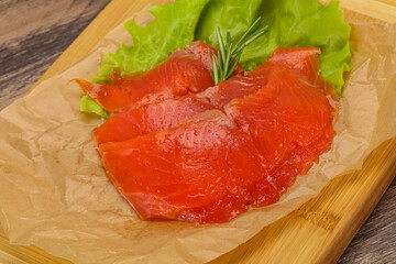 Sliced salmon fillet served rosemary