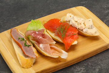 Tapas - bruschetta with prosciutto, salmon, duck and gorgonzola