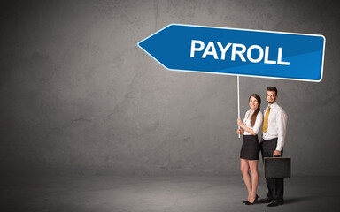 Young business person in casual holding road sign with PAYROLL inscription, new business direction concept