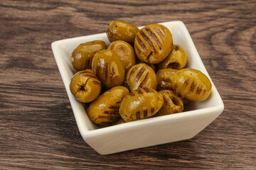 Green grilled olives in the bowl