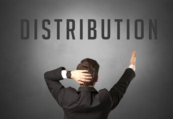 Rear view of a businessman with DISTRIBUTION inscription, powerfull business concept