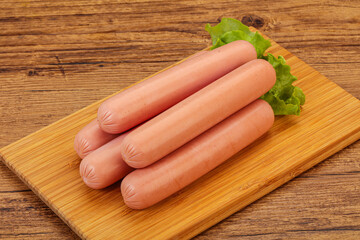 Tasty meat sausages over board
