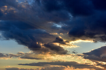 Evening sunset sky with clouds and sun rays