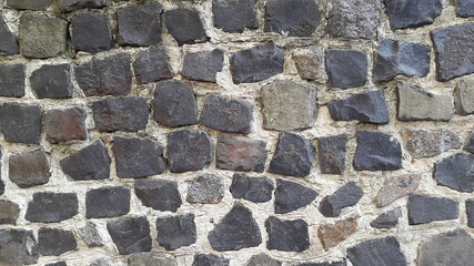 Wall of granite stones. Masonry. Vintage granite background