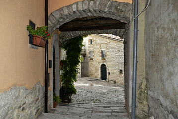 Fototapeta na wymiar A narrow street among the old houses of Ferrazzano, a medieval village in the Molise region. 