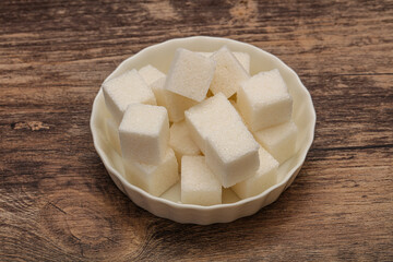 Refined white sugar cubs in the bowl