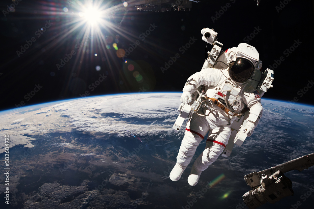 Poster astronaut walking in space with earth background. elements of this image furnished by nasa