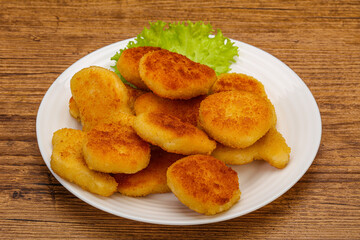 Fried chicken nuggets served salad leaves