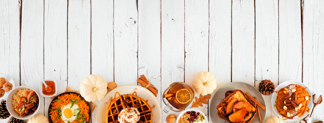 Autumn breakfast or brunch buffet border against a white wood ba