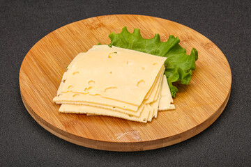Sliced yellow cheese over board