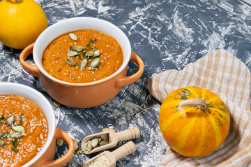 Pumpkin cream soup with seeds, sesame and rucola. Autmn flat lay.