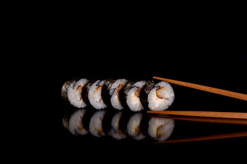 Fresh delicious beautiful sushi rolls on a dark background