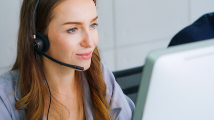 Business people wearing headset working in office to support remote customer or colleague. Call...