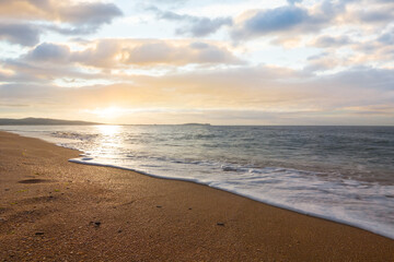 Fototapeta na wymiar sandy sea beach at the sunset, outdoor summer vacation natural background
