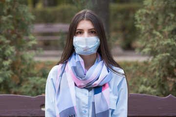 Portrait of a young and beautiful girl in a medical mask. Health care