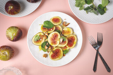 fig salad with almond and thyme herb on colored background