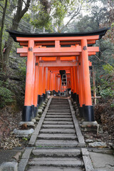 Fototapeta na wymiar Red gate with Japanese words at Fushimi Inari Taisha, Kyoto, Japan.