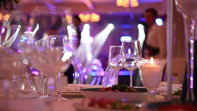 Empty wine glass on table with white tablecloth serving for guests