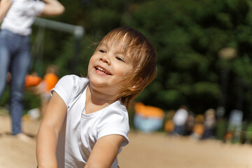 Fototapeta premium beautiful emotional little girl in a white t-shirt. child laughs and is happy