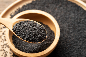 Close up black Sesame on wooden spoon background