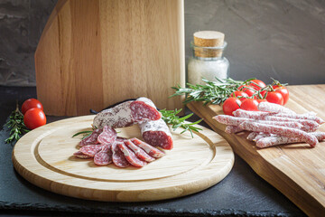 Assorted sliced italian salami on wooden plate