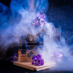 Magical concept. Smoke, boxes and violet flowers