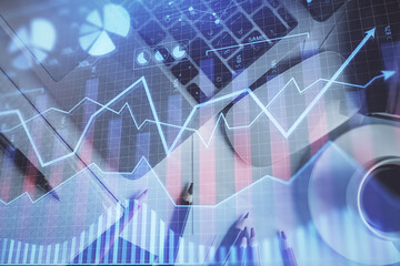 Double exposure of financial chart drawing over table background with computer. Concept of research and analysis. Top view.