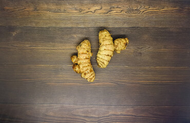 Ginger on the wooden background. Healthy herbal spices. 
