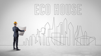 Businessman in hard hat holding blueprint with ECO HOUSE inscription, engineering and architecture concept