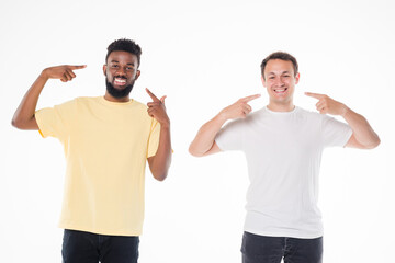 Two mixed race handsome men posing together pointed on smile isolated over white background