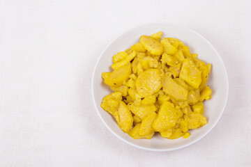 Stewed potato with spices in bowl.